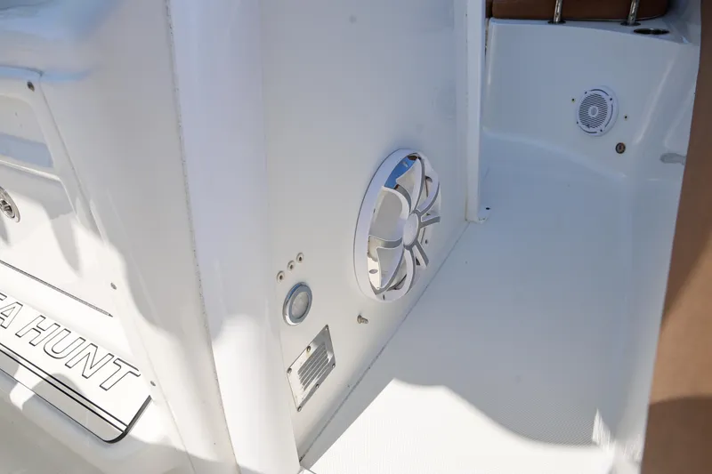 Slide: The Image of 2019 Sea Hunt Ultra 255 SE boat interior with speaker and clean white deck. - 16