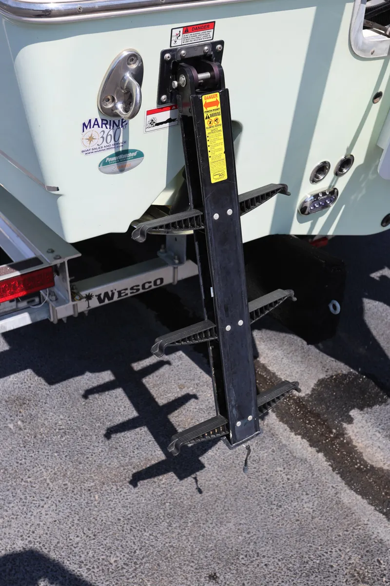 Slide: The Image of Rear view of 2019 Sea Hunt Ultra 255 SE boat ladder and trailer. - 23