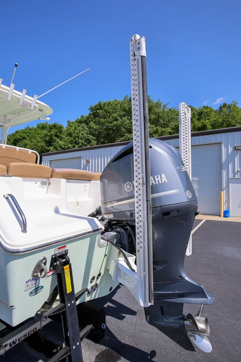 Slide: The Image of 2019 Sea Hunt Ultra 255 SE boat with Yamaha outboard motor, parked outdoors. - 24