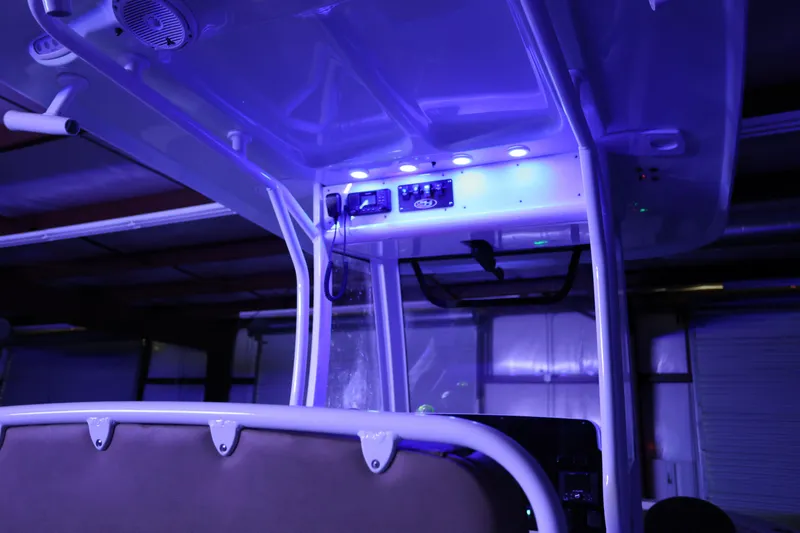 Slide: The Image of 2019 Sea Hunt Ultra 255 SE boat interior with blue LED lighting. - 27