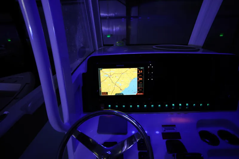 Slide: The Image of 2019 Sea Hunt Ultra 255 SE boat dashboard with illuminated navigation screen. - 30