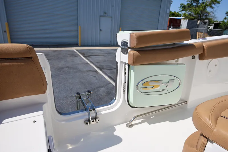 Slide: The Image of 2019 Sea Hunt Ultra 255 SE boat interior with tan seating and SH logo. - 6