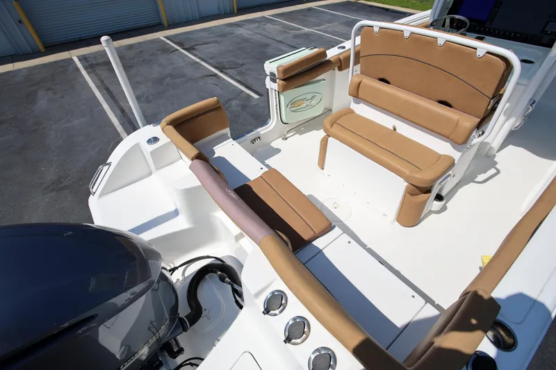Slide: The Image of 2019 Sea Hunt Ultra 255 SE boat interior with tan seating and engine view. - 7