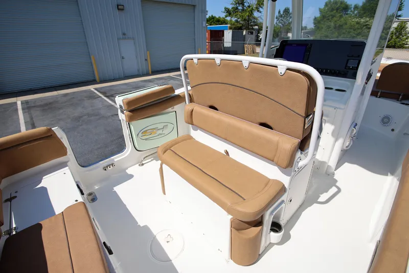Slide: The Image of 2019 Sea Hunt Ultra 255 SE boat interior with tan seating and modern console. - 8
