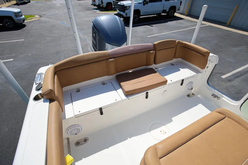Slide: The Image of 2019 Sea Hunt Ultra 255 SE boat interior with tan seating and storage compartments. - 9