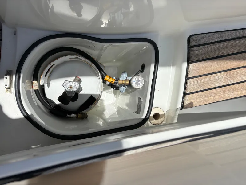 Slide: The Image of 2018 Jeanneau Merry Fisher 855 boat compartment with equipment and wiring. - 10