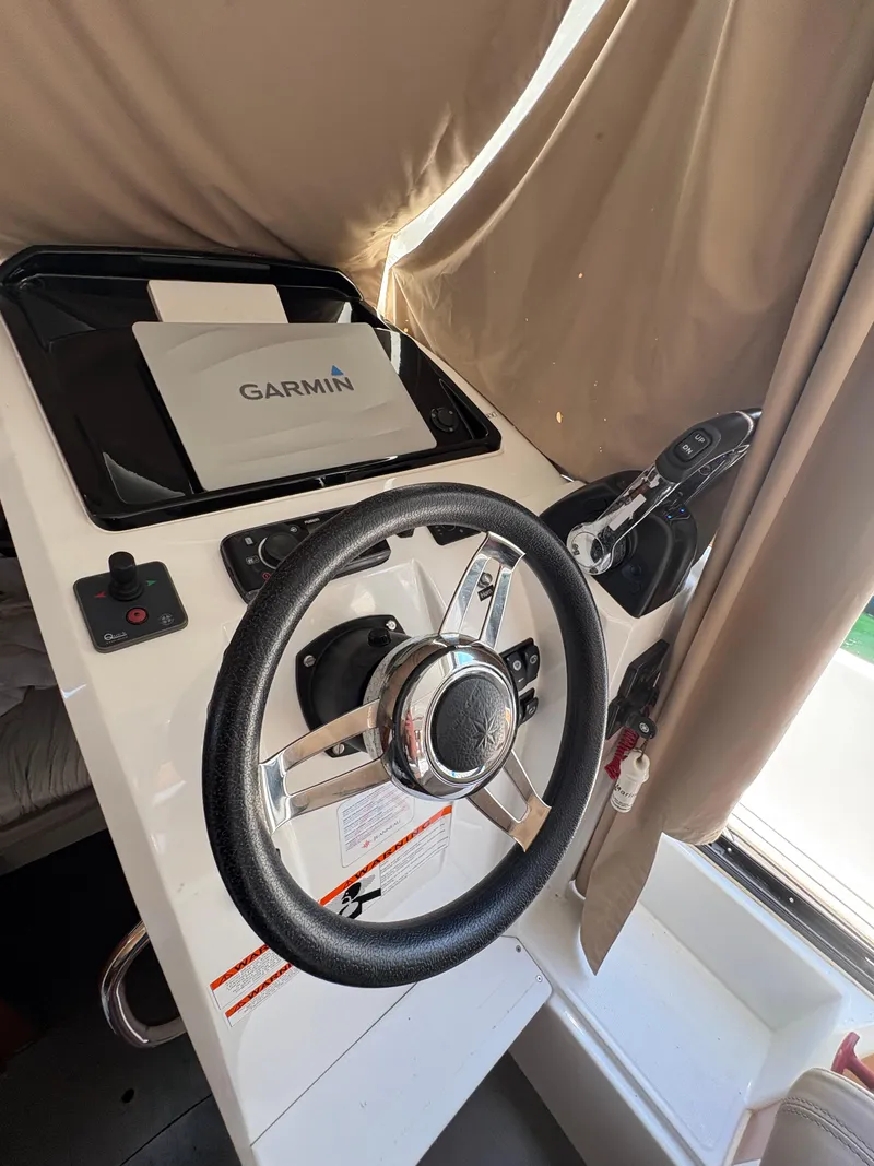 Slide: The Image of Steering wheel and controls of a 2018 Jeanneau Merry Fisher 855 boat. - 16