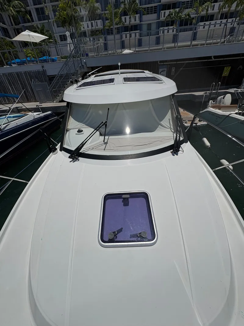 Slide: The Image of 2018 Jeanneau Merry Fisher 855 boat docked, showcasing sleek design and modern features. - 21