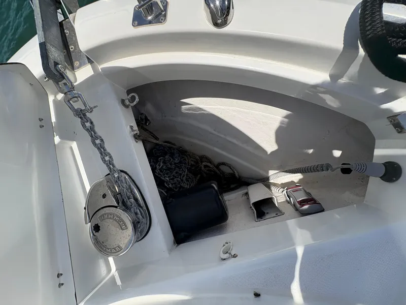 Slide: The Image of Anchor compartment of 2018 Jeanneau Merry Fisher 855 boat with chain and equipment. - 24