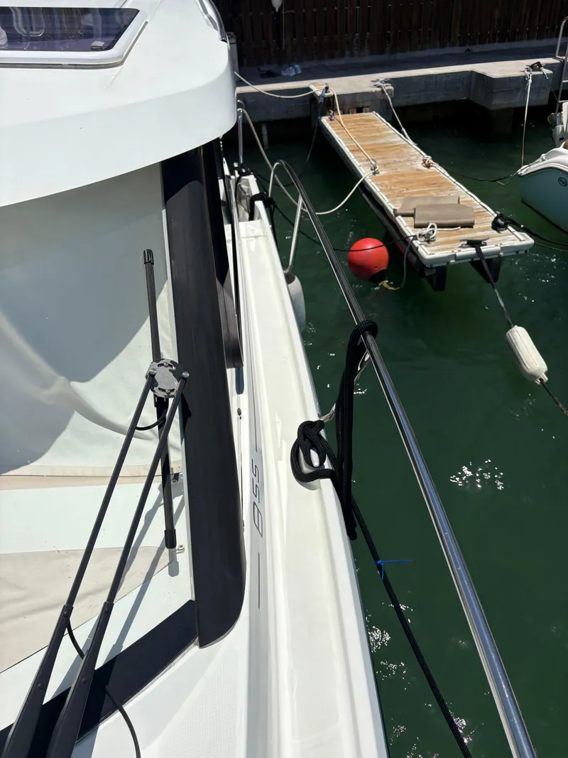 Slide: The Image of 2018 Jeanneau Merry Fisher 855 docked at marina with visible walkway and mooring lines. - 26