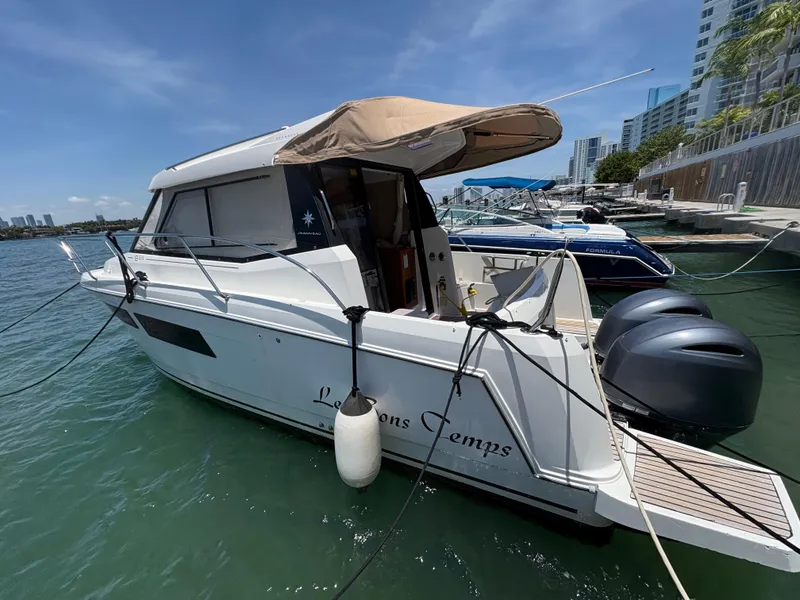 Slide: The Image of 2018 Jeanneau Merry Fisher 855 boat docked at marina, featuring twin outboard engines. - 3