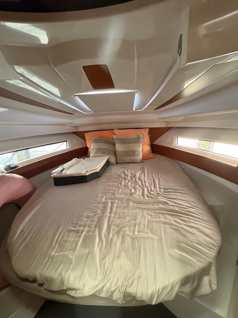 Slide: The Image of 2018 Jeanneau Merry Fisher 855 cabin with cozy bed and pillows. - 34