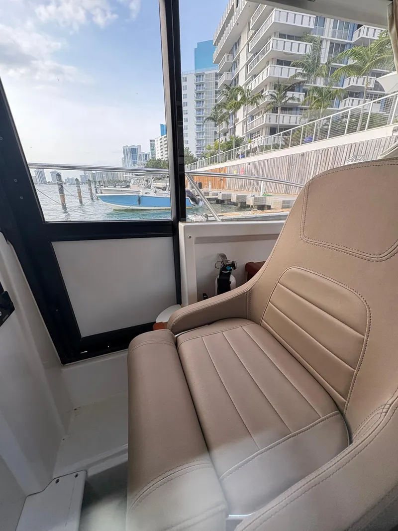 Slide: The Image of Interior view of 2018 Jeanneau Merry Fisher 855 boat with waterfront cityscape. - 35