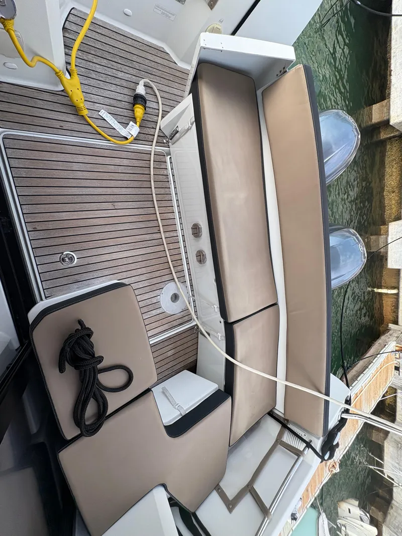 Slide: The Image of 2018 Jeanneau Merry Fisher 855 boat deck with seating and mooring ropes. - 38