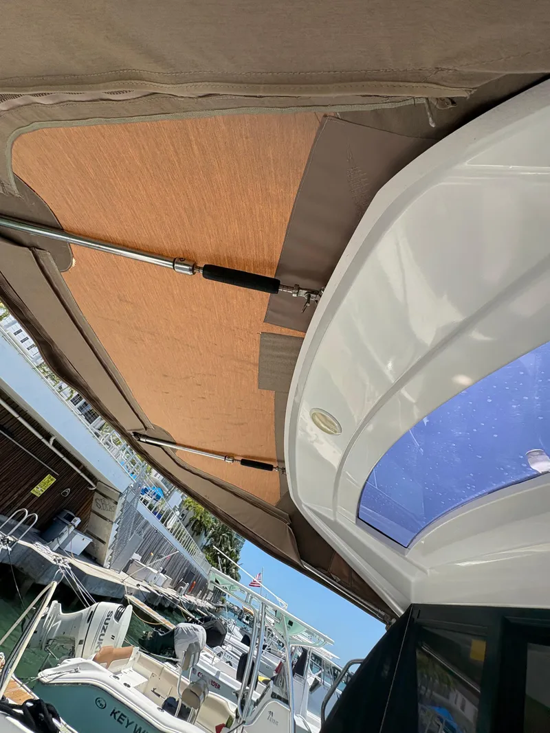 Slide: The Image of 2018 Jeanneau Merry Fisher 855 boat with sunshade and marina view. - 7