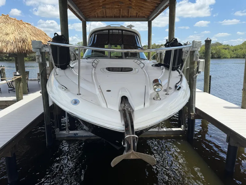Slide: The Image of 2008 Sea Ray 330 Sundancer docked under a wooden canopy on a sunny day. - 10