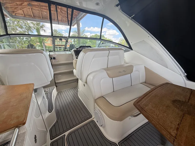 Slide: The Image of 2008 Sea Ray 330 Sundancer interior with white seating and wood accents. - 11