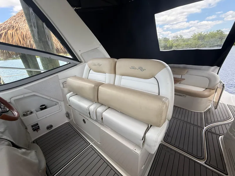 Slide: The Image of 2008 Sea Ray 330 Sundancer interior with beige seating and sleek design. - 16