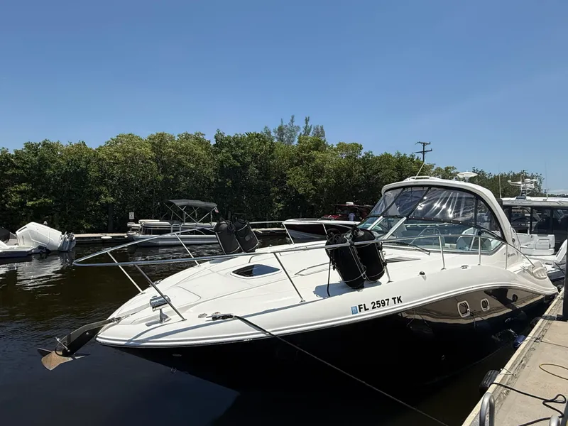 Slide: The Image of 2008 Sea Ray 330 Sundancer docked in a marina under clear blue skies. - 2