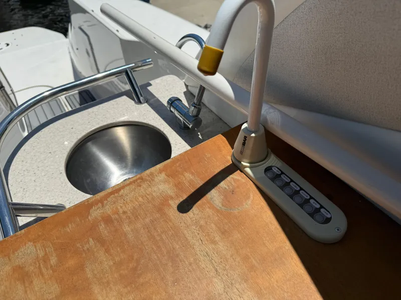 Slide: The Image of 2008 Sea Ray 330 Sundancer boat sink and control panel on deck. - 24