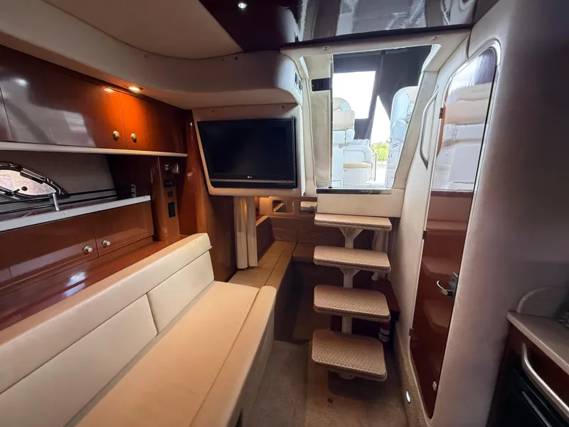 Slide: The Image of Interior of 2008 Sea Ray 330 Sundancer yacht with seating, TV, and stairs. - 28