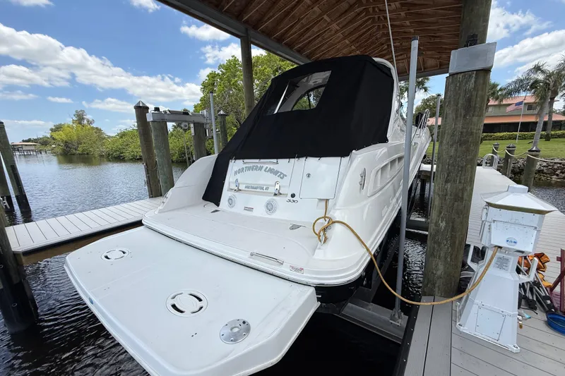 Slide: The Image of 2008 Sea Ray 330 Sundancer docked under a wooden canopy on a sunny day. - 3