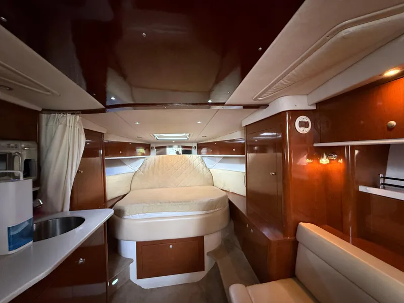 Slide: The Image of Luxurious interior of 2008 Sea Ray 330 Sundancer yacht with cozy bed and kitchenette. - 32