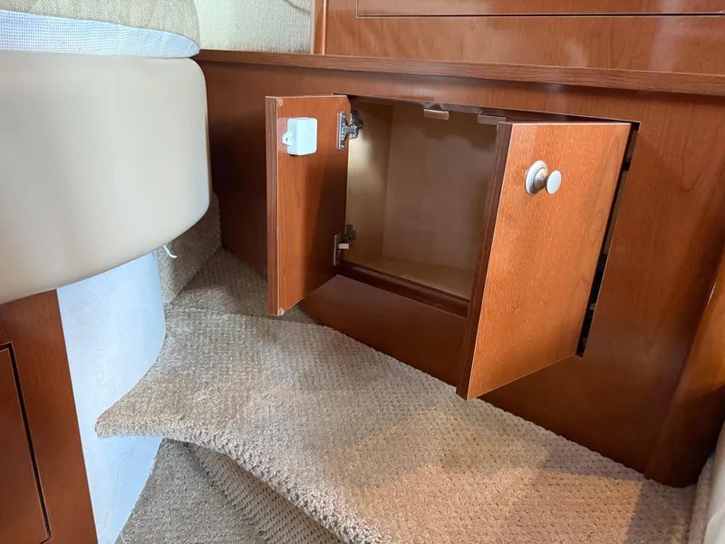 Slide: The Image of Open wooden cabinet on carpeted stairs inside 2008 Sea Ray 330 Sundancer boat. - 33