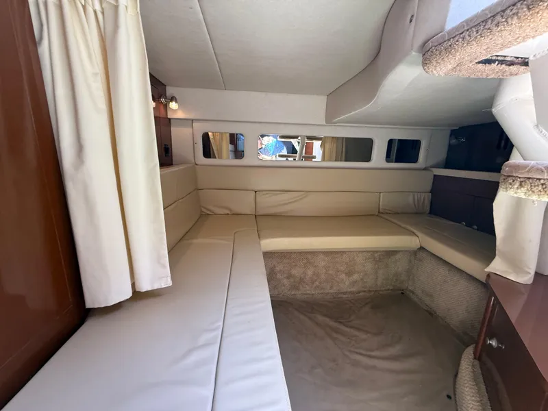 Slide: The Image of Interior cabin of 2008 Sea Ray 330 Sundancer with beige seating and curtains. - 34