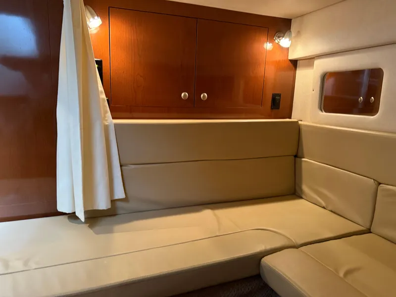Slide: The Image of Interior cabin of 2008 Sea Ray 330 Sundancer with beige seating and wooden cabinets. - 36