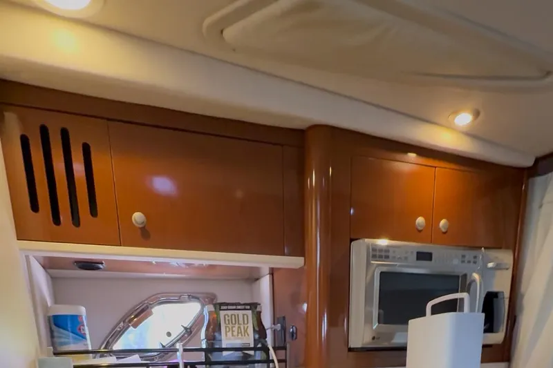 Slide: The Image of Interior of 2008 Sea Ray 330 Sundancer with wooden cabinets and microwave. - 40