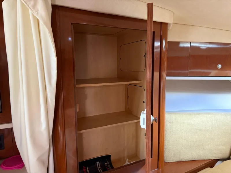 Slide: The Image of Open wooden cabinet inside 2008 Sea Ray 330 Sundancer boat interior. - 42