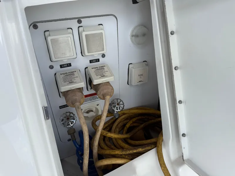 Slide: The Image of Electrical panel of 2008 Sea Ray 330 Sundancer with cables and switches. - 49