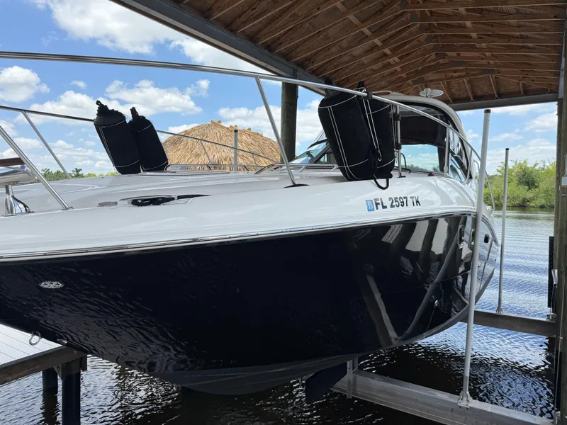 Slide: The Image of 2008 Sea Ray 330 Sundancer boat docked under a wooden canopy. - 5