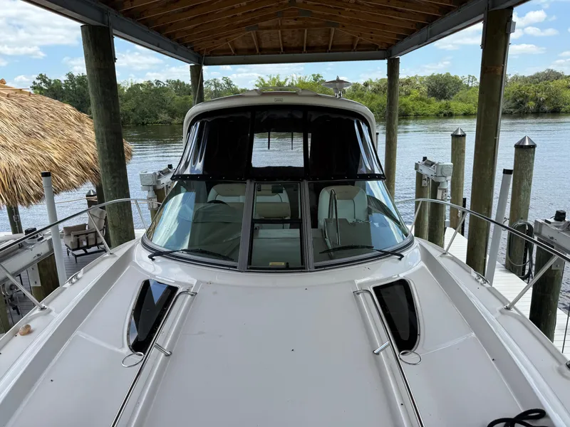 Slide: The Image of 2008 Sea Ray 330 Sundancer docked under a wooden canopy by a serene river. - 9