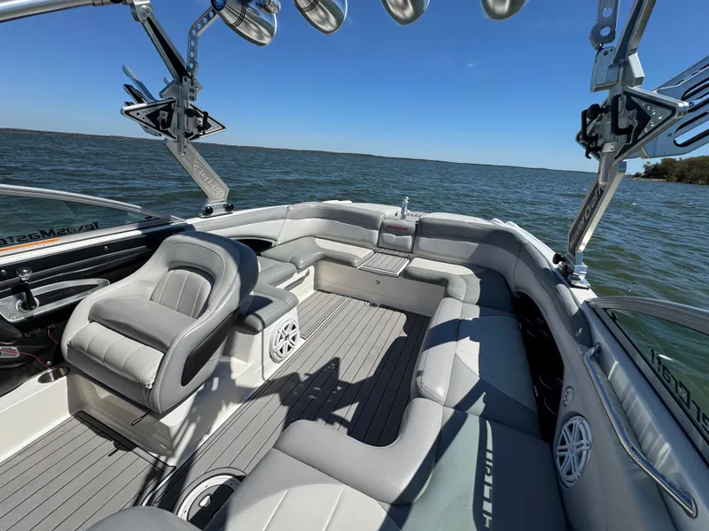 Slide: The Image of 2008 MasterCraft X45 boat interior with gray seating, on a sunny day at sea. - 16
