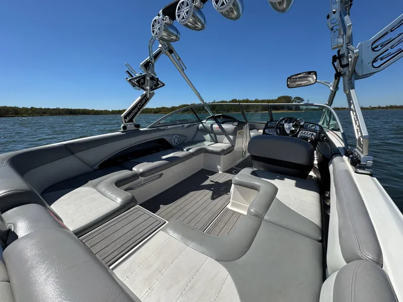 Slide: The Image of 2008 MasterCraft X45 boat interior with sleek seating and advanced audio system on a sunny day. - 18