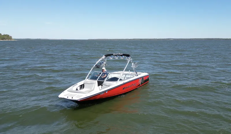 Slide: The Image of 2008 MasterCraft X45 boat on open water under clear blue sky. - 2