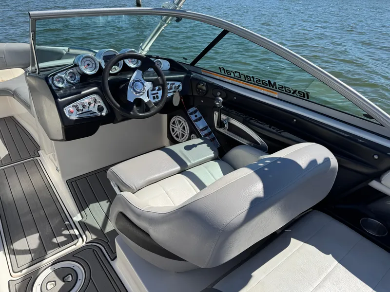 Slide: The Image of 2008 MasterCraft X45 boat interior with steering wheel and dashboard, on a sunny day. - 24
