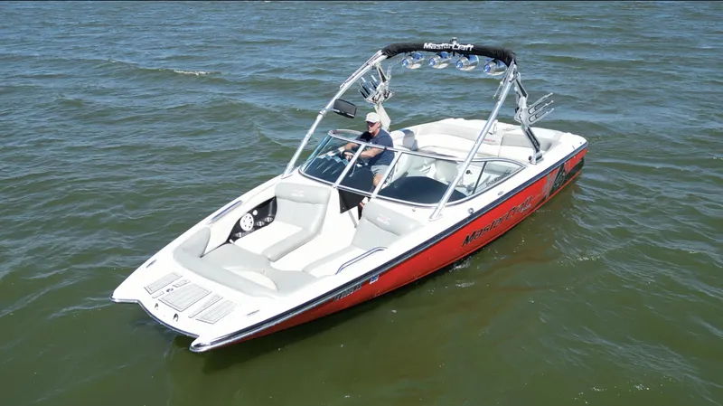 Slide: The Image of 2008 MasterCraft X45 boat on water, featuring sleek design and vibrant red accents. - 3