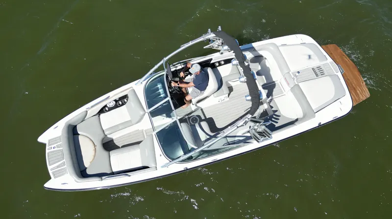 Slide: The Image of 2008 MasterCraft X45 boat on water, aerial view, with driver at helm. - 5