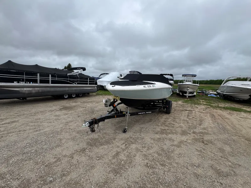 Slide: The Image of 2021 Regal 1900 ES boat on trailer, parked outdoors under cloudy skies. - 3