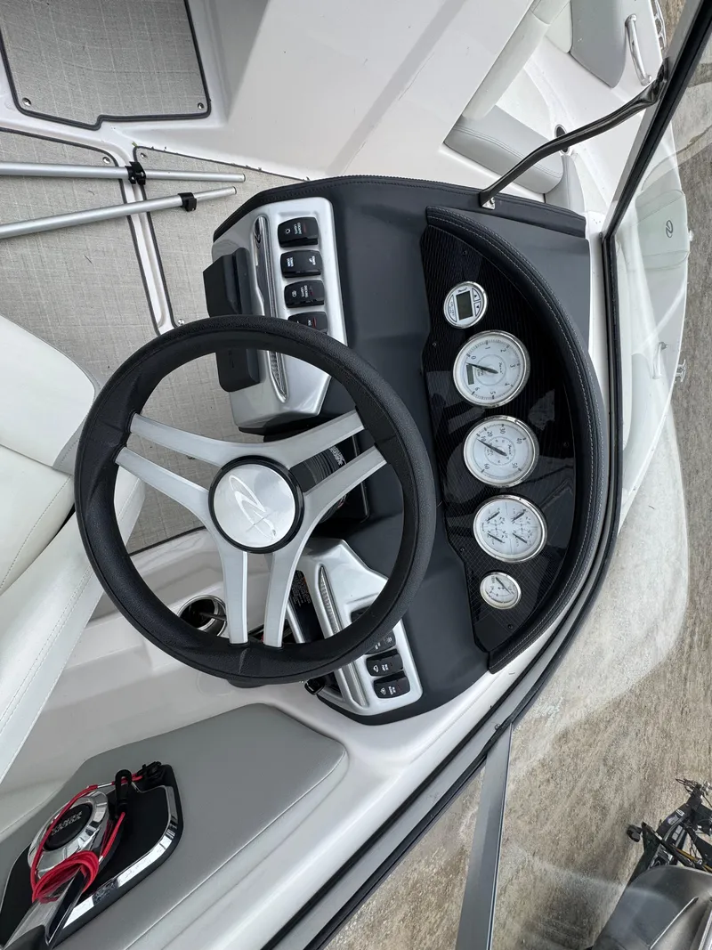 Slide: The Image of 2021 Regal 1900 ES boat dashboard with steering wheel and gauges. - 5