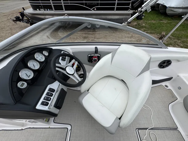 Slide: The Image of Interior of a 2021 Regal 1900 ES boat showing steering wheel and dashboard controls. - 6