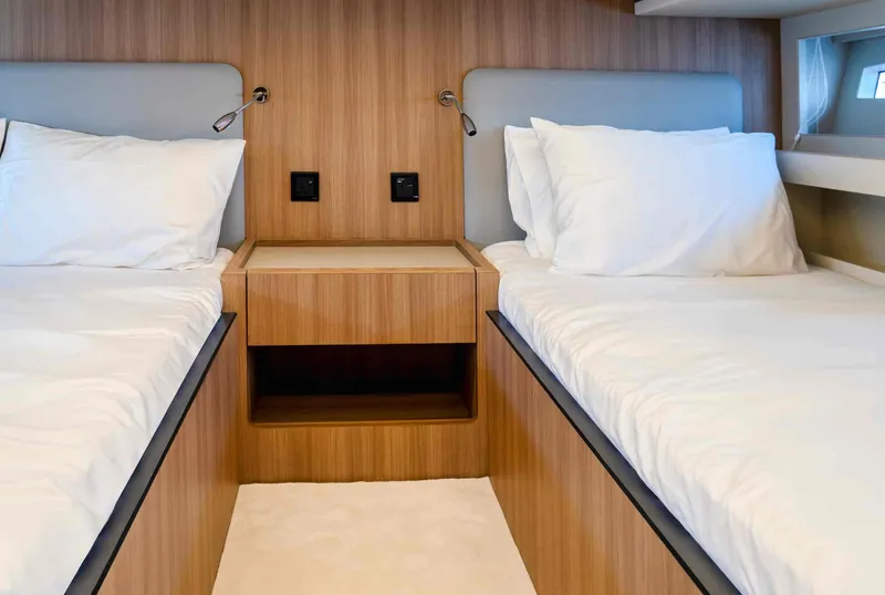 Slide: The Image of Twin beds in a luxurious 2025 Oryx 47 LX yacht cabin with modern wood finish. - 11