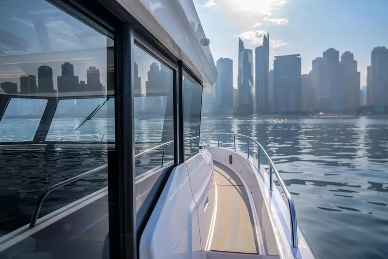 Slide: The Image of Oryx 47 LX yacht cruising near city skyline, 2025 model. - 5