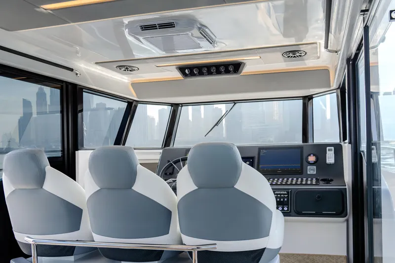 Slide: The Image of Interior of 2025 Oryx 47 LX boat with modern cockpit and seating. - 7