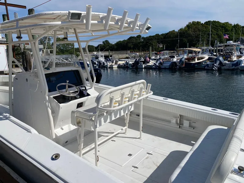 Slide: The Image of 2004 Jupiter 31 FS boat in a warehouse with American flag backdrop. - 11