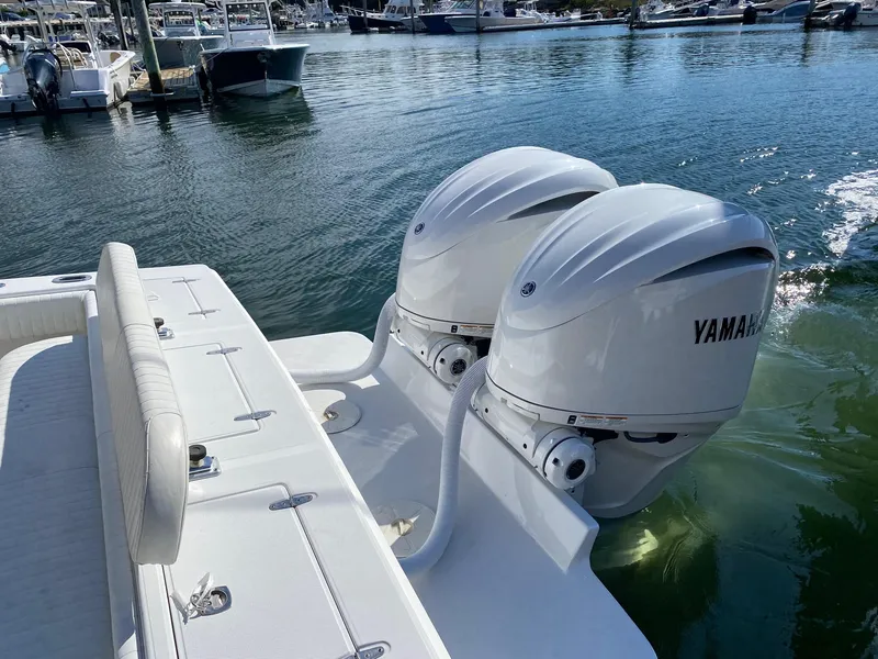 Slide: The Image of Steering console of a 2004 Jupiter 31 FS boat with Mercury controls and Simrad display. - 12