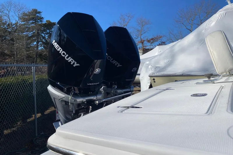 Slide: The Image of 2004 Jupiter 31 FS boat interior with seating, docked at a marina. - 15